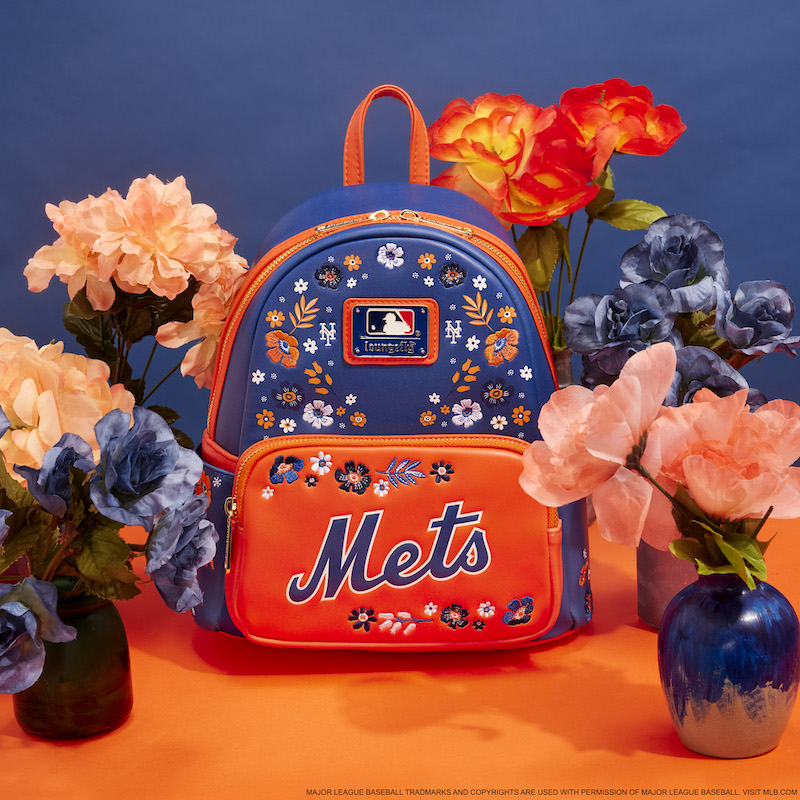 Blue and orange floral Loungefly New York Mets mini backpack against a blue and orange background and surrounded by blue and orange flowers 